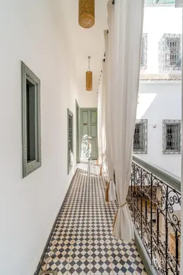 a hallway with a curtain on a balcony at Riad Nafora in Marrakech