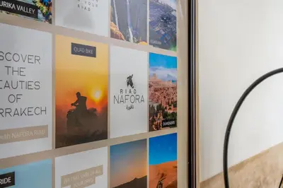a display of posters on a wall at Riad Nafora in Marrakech