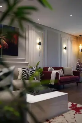 a living room with a couch and a table at Appartement Central, vue Piscine-Golf, Lac et Montagne de L'atlas in Marrakech