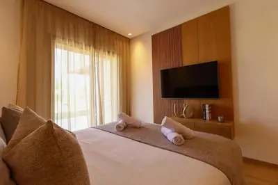 a bedroom with a bed with towel animals on it at Hevernage penthouse in Marrakech
