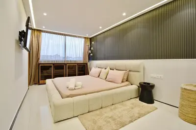 a bed in a room with a couch and a window at Hevernage penthouse in Marrakech