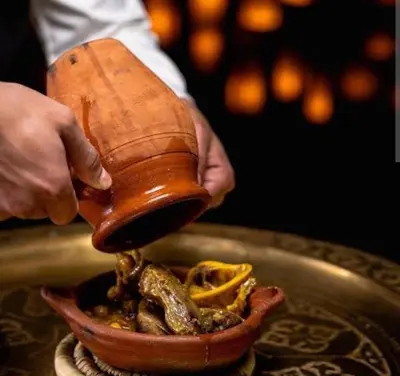 a person is holding a hand mixer over a bowl of food at Appart de luxe a gueliz a bon prix in Marrakech