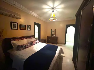 a bedroom with a large bed in a room at Appartement impeccable en plein de centre ville in Marrakech