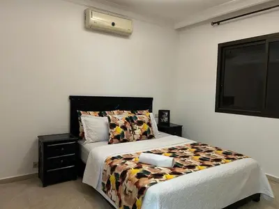 a bedroom with a bed and a window at Appartement au cœur de centre ville in Marrakech