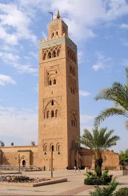 a tall building with a clock tower on top of it at Appartement au cœur de centre ville in Marrakech