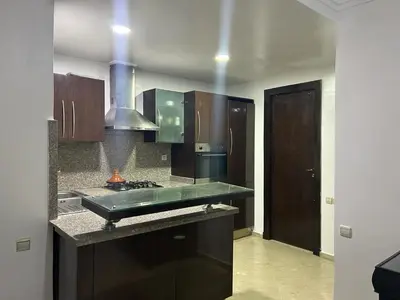 a kitchen with a sink and a stove top oven at Appartement au cœur de centre ville in Marrakech