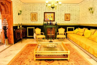 a living room with a couch and a table at The Riad Palace - Gym - Spa - Tennis Court in Marrakech