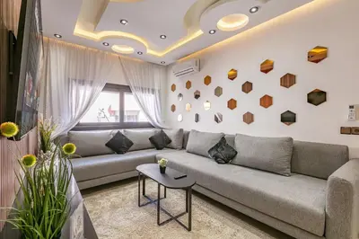 a living room with a couch and a table at Modern New Appartement Fully Equiped In Center of guéliz in Marrakech
