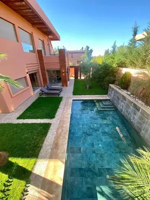 a swimming pool in the yard of a house at villa de luxe avec piscine privée in Marrakech