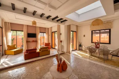 a living room with a couch and a table at Villa Leya - Piscine chauffée in Marrakech