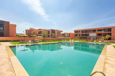 a large swimming pool in front of a building at New! Appt Charme, Elégance à NORIA GOLF in Marrakech