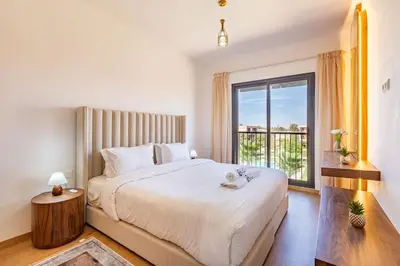 a bedroom with a large bed and a large window at New! Appt Charme, Elégance à NORIA GOLF in Marrakech