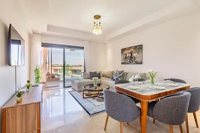 a living room with a couch and a table at New! Appt Charme, Elégance à NORIA GOLF in Marrakech