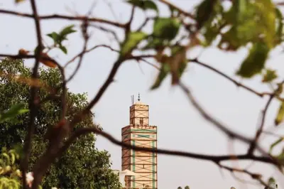 a tall building with a tower in the background at Maison traditionnelle au cœur de la Médina in Marrakech