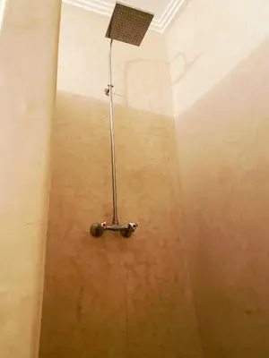 a shower with a shower head in a room at Maison traditionnelle au cœur de la Médina in Marrakech