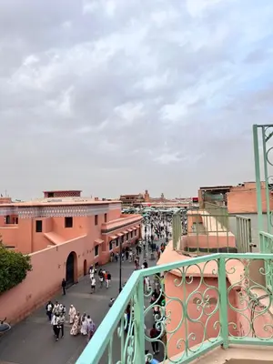 a group of people walking down a street at Square Appart in Marrakech