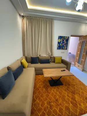 a living room with a couch and a coffee table at Square Appart in Marrakech