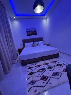 a bedroom with a bed and a blue ceiling at Square Appart in Marrakech