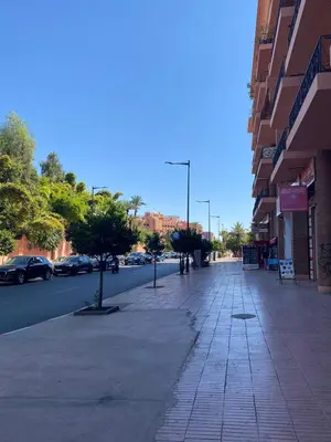 an empty street with cars parked on the side of a building at Appartement cosy à deux pas du Jardin Majorelle in Marrakech