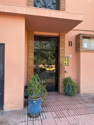 a door to a building with two potted plants in front at Appartement cosy à deux pas du Jardin Majorelle in Marrakech