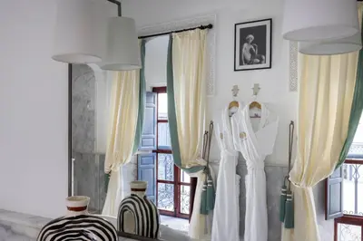 a bathroom with white curtains and a window at Riad Laz Mouassine & Wellness in Marrakech