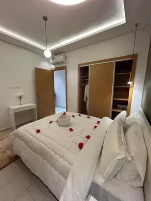 a bedroom with a large bed with roses on it at JASMINe in Marrakech