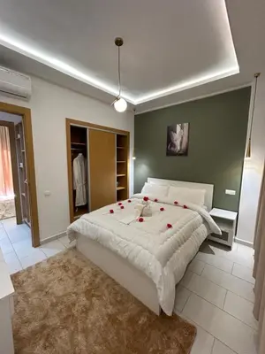 a bedroom with a large bed with roses on it at JASMINe in Marrakech