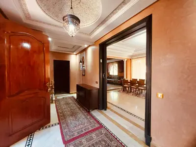 a hallway with a door leading to a dining room at Naoura House in Marrakech