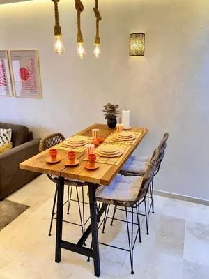 a wooden table in a living room with chairs at Pearl Garden Studio Cosy Lux Elegant Sunny Terrace Piscine in Marrakech