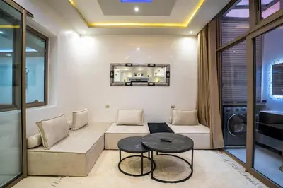 a living room with a couch and a table at Appartement cosy au cœur de Semlalia in Marrakech