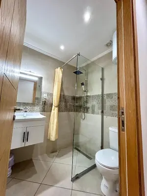 a bathroom with a shower and a toilet and a sink at Appartement a Gueliz in Marrakech