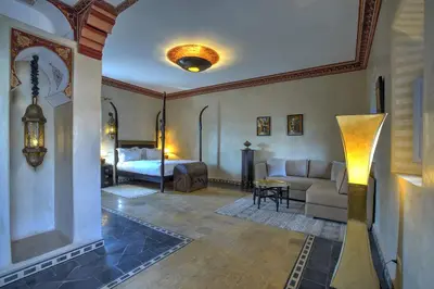 a living room with a couch and a bed at Ksar Anika Boutique Hotel & Spa in Marrakech