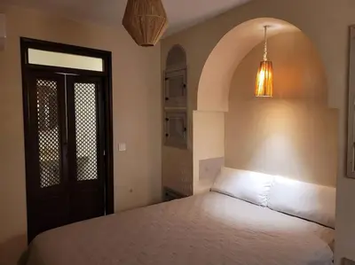 a bedroom with a bed and a black door at Dar Amazigh mit 3 Schlafzimmern in Marrakech