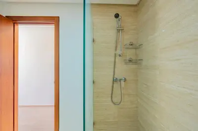a shower in a bathroom with a glass door at Cute And Modern Appart In Prestigia in Marrakech
