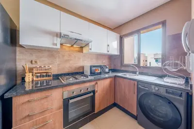 a kitchen with a washing machine and a washer at 2Bedrooms In Prestigia - Very Well Equipped With View in Marrakech