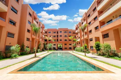 a swimming pool in the middle of a building at Appartement Piscine & Parking in Marrakech