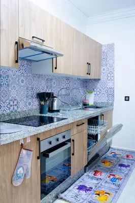 a kitchen with a sink and a counter top at Appartement Piscine & Parking in Marrakech