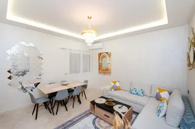 a living room with a couch and a table at Appartement Piscine & Parking in Marrakech