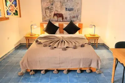 a bedroom with a large bed with two tables at Riad LakLak Nouvelle 400m2 mit Pool in der Medina in Marrakech