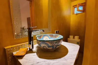 a bathroom with a sink and a bowl on a counter at Riad LakLak Nouvelle 400m2 mit Pool in der Medina in Marrakech