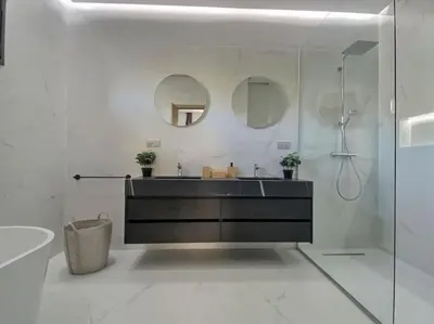 a bathroom with a sink and a shower with mirrors at Villa Léna détente en famille ! in Marrakech