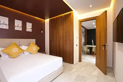 a bedroom with a white bed and a table at Brand New and Stylish appart hotel Best location in Marrakech