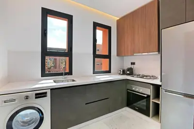 a kitchen with a washer and a dishwasher at Brand New and Stylish appart hotel Best location in Marrakech