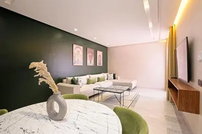 a living room with a table and a couch at Brand New and Stylish appart hotel Best location in Marrakech