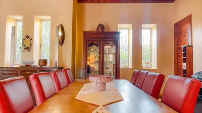 a dining room with a table and red chairs at Villa des Rêves in Marrakech