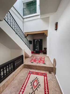 a hallway with a staircase with a rug on the floor at Riad Dar Habiba 120m2 in der Medina mit Terrasse in Marrakech
