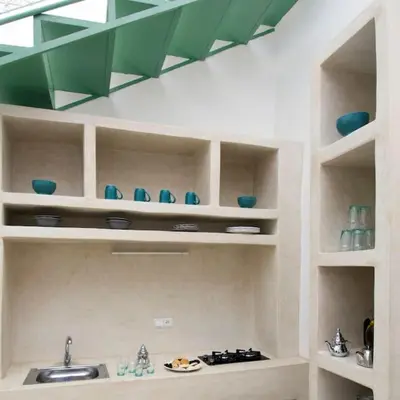a kitchen with a sink and blue bowls on shelves at Riad Haloma 90m2 in der Medina mit Terrasse in Marrakech