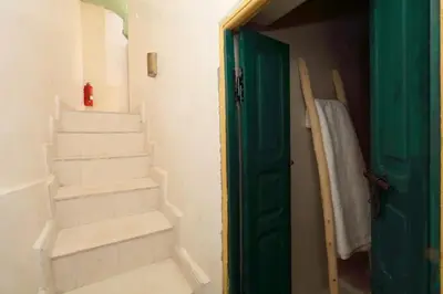 a bathroom with stairs and a green door at Riad Haloma 90m2 in der Medina mit Terrasse in Marrakech