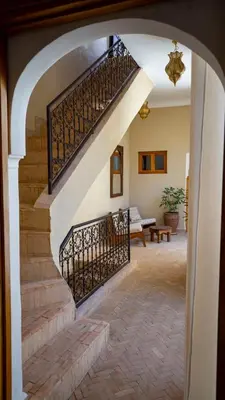 an archway leading to a staircase in a house at Riad Saadaoui in Marrakech