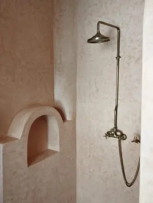 a shower in a bathroom with a shower head at Riad Saadaoui in Marrakech